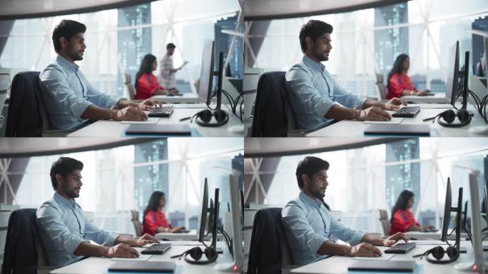 一位印度商人在一家金融科技初创公司的台式电脑上工作的肖像。南亚金融分析师对新兴亚洲科技股市场进行研究