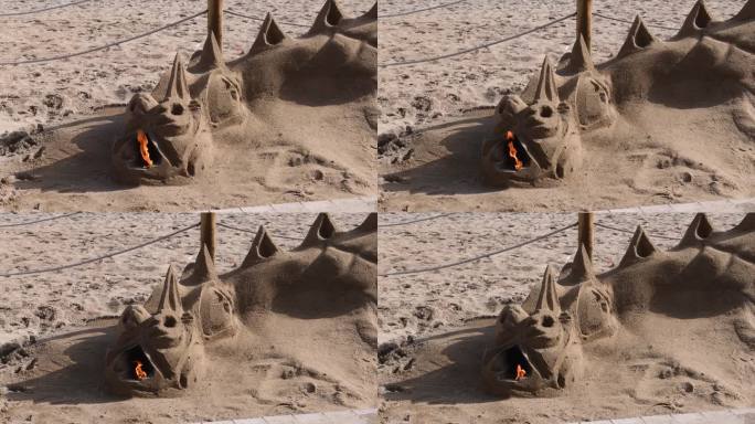 建造喷火龙形状的沙雕。火从沙龙口燃烧