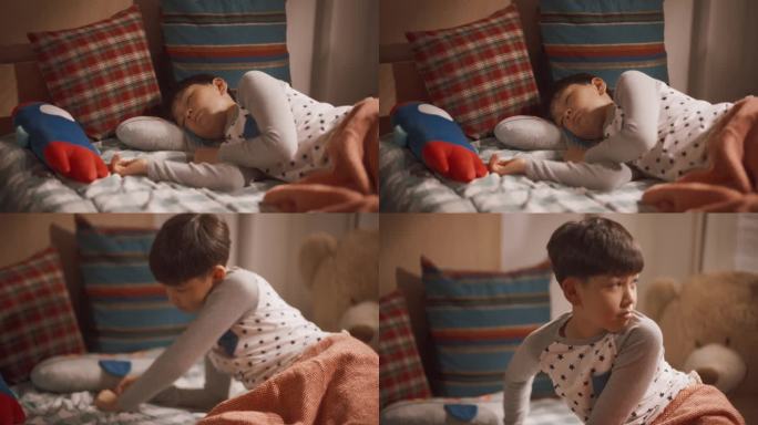 可爱的韩国男孩在阳光明媚的儿童房的床上醒来的肖像。超级可爱的孩子准备好了一个充满冒险的阳光明媚的一天
