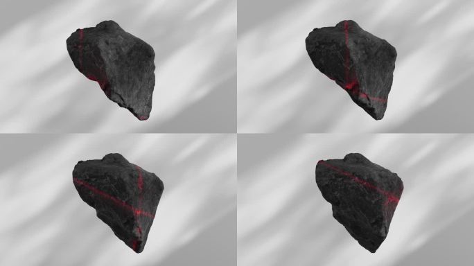 一束红色的激光扫描着一块黑色石头的表面