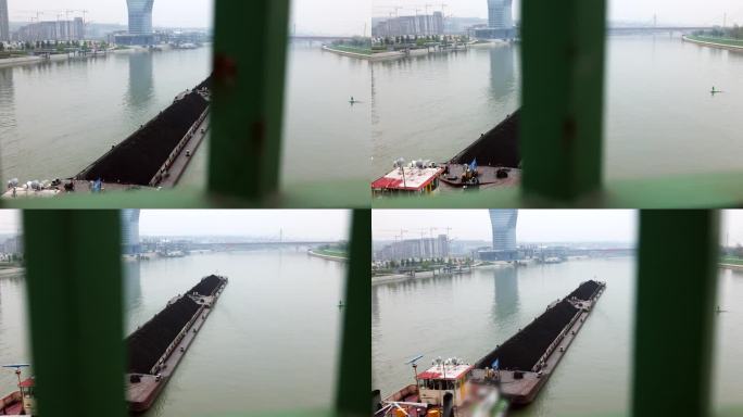 集装箱货船在桥下的水面上行驶