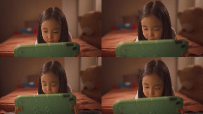 体贴的亚洲女孩在孩子的卧室里用平板电脑学习。可爱的天才韩国孩子思考，解决问题的数字练习上的设备
