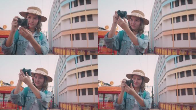 年轻的亚洲女性背包旅行者在城市中使用相机。旅行的生活方式。世界旅游探索者或亚洲夏季旅游概念。