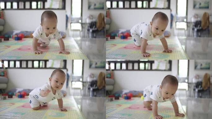 8个月大的小男孩在家里开心地玩着五颜六色的玩具