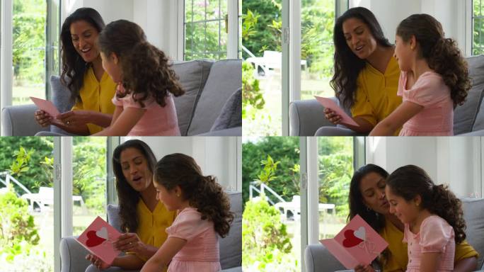 女儿送母亲自制卡片在家庆祝生日或母亲节