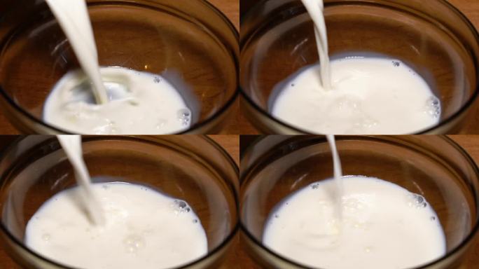 鲜牛奶倒进木桌上的碗里。