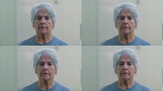 一位老年妇女的特写脸，表情中性。70多岁的白发老人