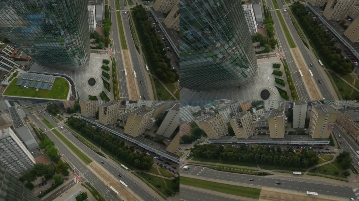 第一人称视角无人机飞行通过现代城市街道在白天未来的摩天大楼