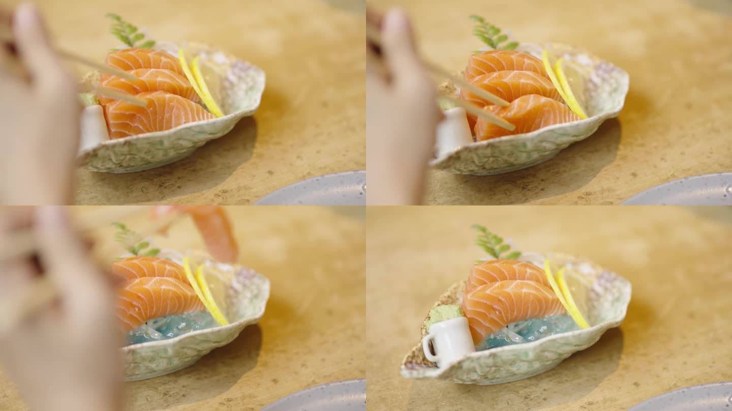 三文鱼生鱼片被从生鱼片碗中取出的特写镜头