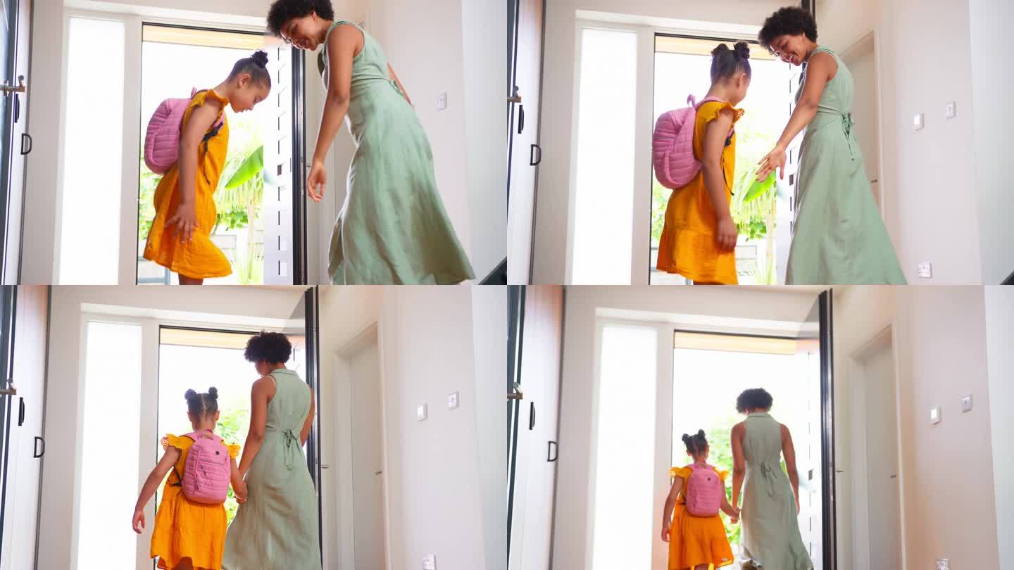 母亲在家里帮助女儿准备和离开一起去上学