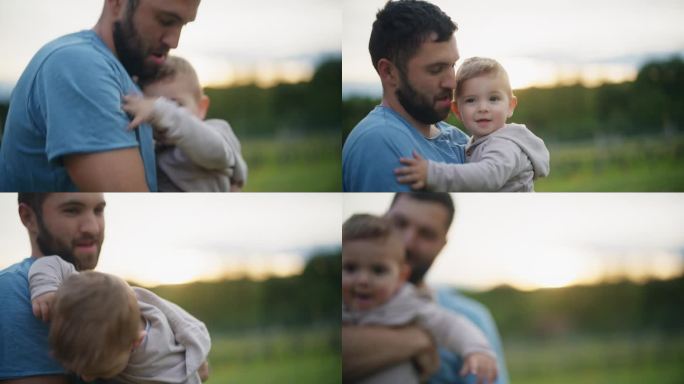 慢镜头男子在乡下户外抱着一个男婴。父与子