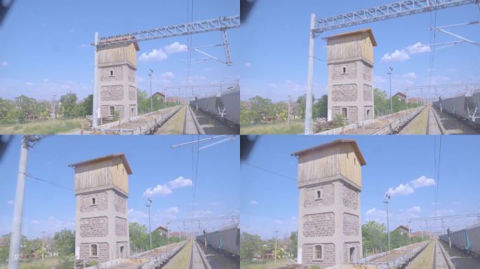 在偏远的农村地区，白天缓慢到达干线货运列车的4K镜头。砖和木塔从机车司机的角度看POV股票视频。