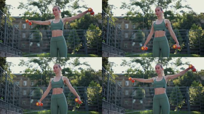 运动年轻肌肉健身女孩早上站在运动场上做侧哑铃举。体重锻炼，有氧运动，半身锻炼。积极生活方式的概念。