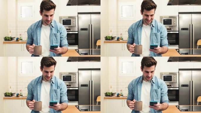 帅气快乐的男人在厨房边喝茶边看手机。年轻人悠闲地站在家里。生活方式的概念。