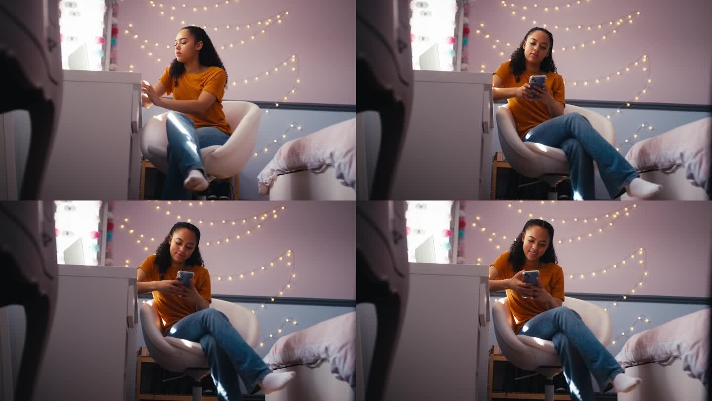 十几岁的女孩在家里的卧室里看手机，用笔记本电脑学习