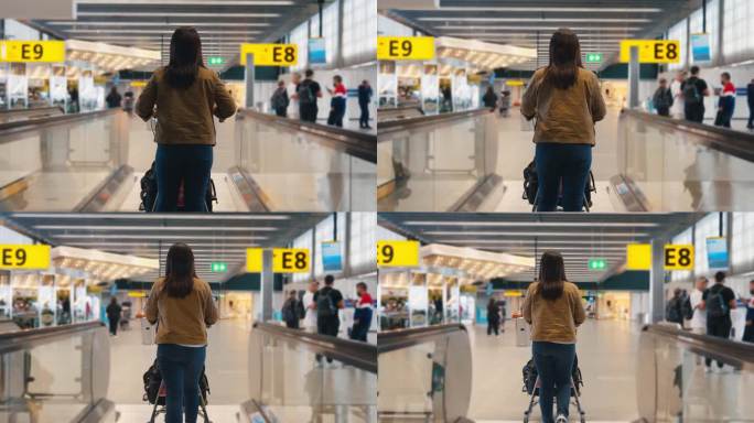 亚洲女乘客在机场免税店推着机场行李车，走在人行道自动扶梯上的后视图，慢镜头