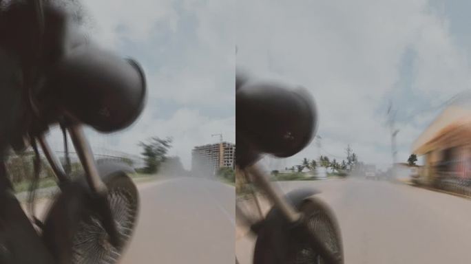 一枚摩托车子弹在乡村公路上加速行驶的低角度超缩镜头