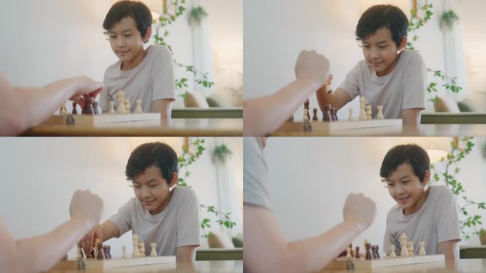 周末，一个亚洲男孩和他爸爸在家里下棋，玩得很开心。