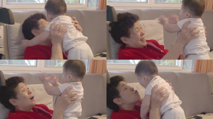 一位亚洲祖母抱着她八个月大的孙子，充满了真挚的爱