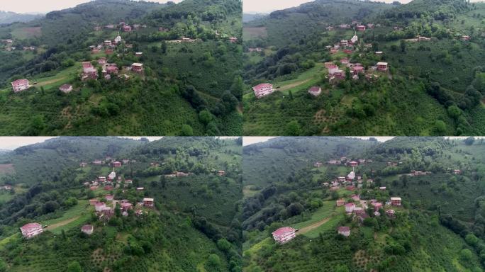 航拍的一个小村庄在绿色的山脉