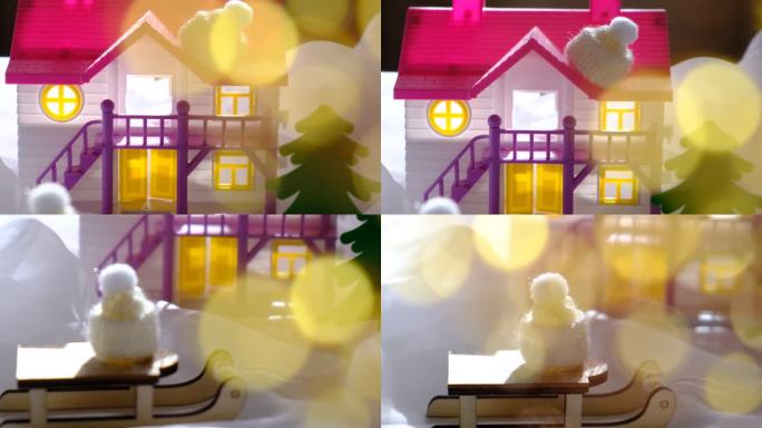 冬季和圣诞节的概念。雪花玻璃球，雪橇，娃娃屋和童话般的魔法气氛，金色的散景