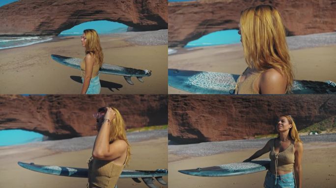 金发碧眼的年轻女子腋下夹着冲浪板，看着大海，然后把太阳镜戴在头发上