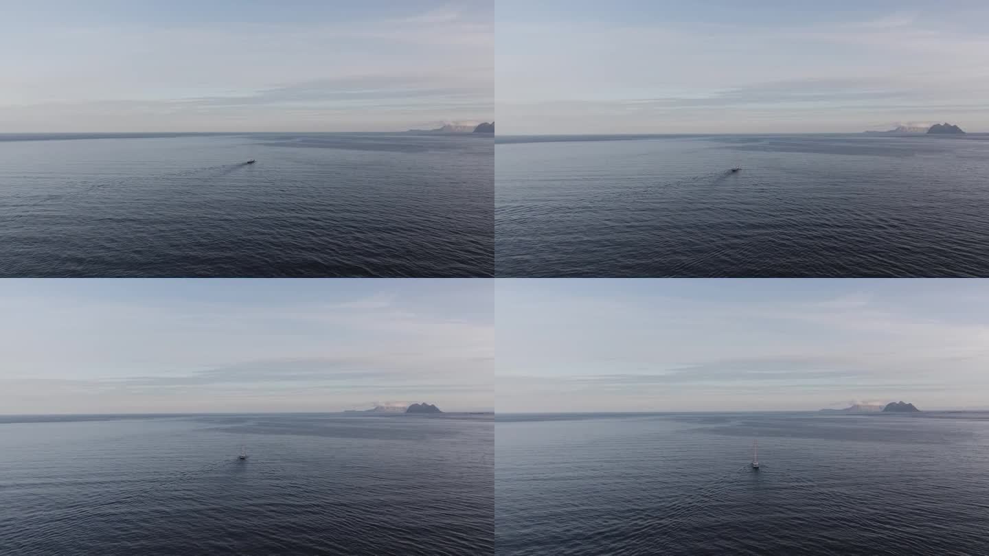 在挪威罗弗敦，一架无人机的4k镜头拍下了海洋上一艘孤独的船，周围是白雪覆盖的山脉。