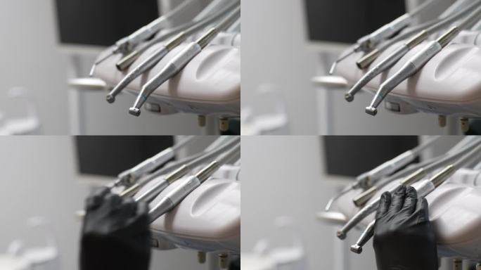 戴着橡胶手套、无法辨认的牙医的手从一套牙科工具中取出电钻，为牙痛患者治疗