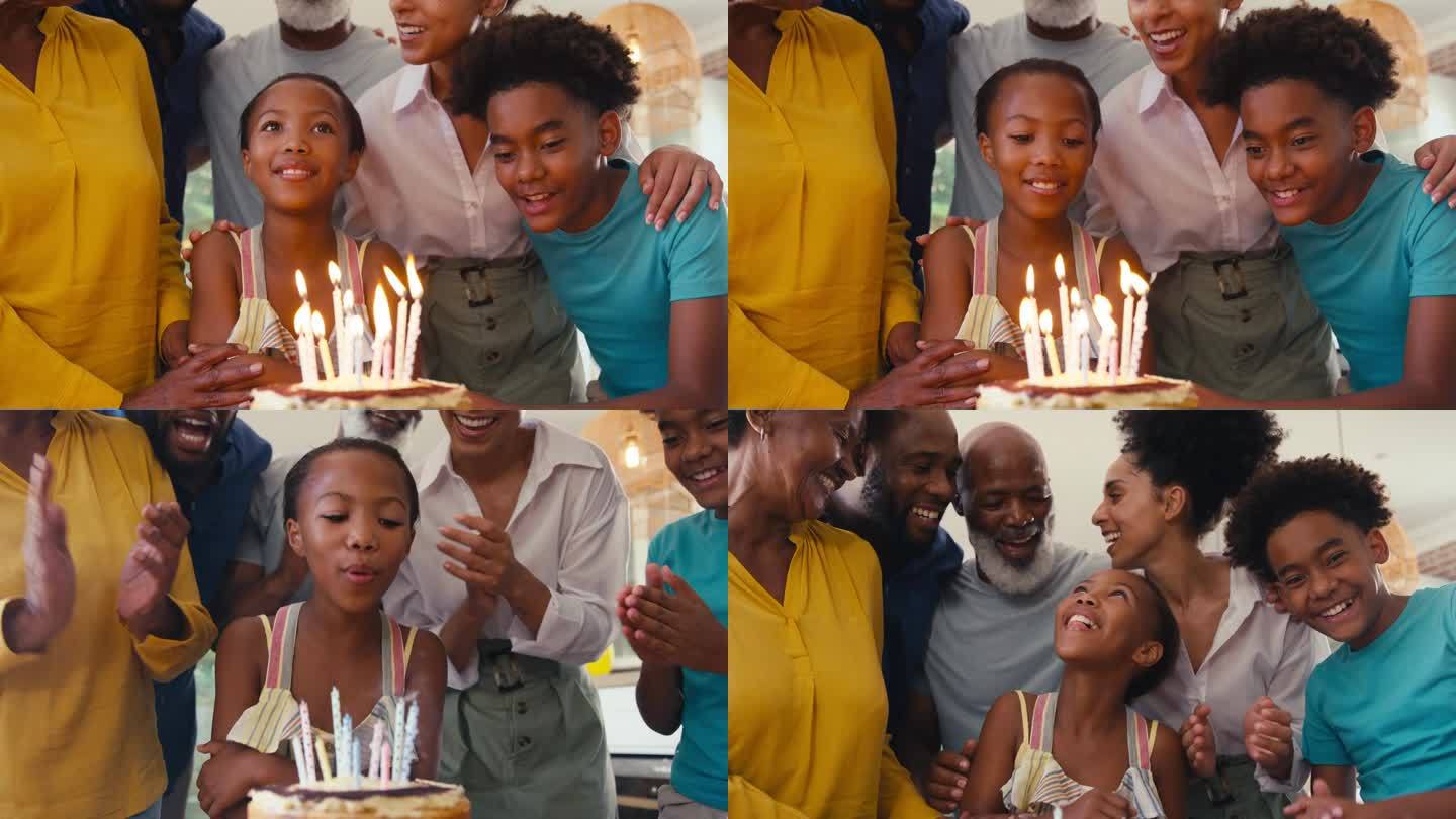 几代同堂的家庭在家里用蛋糕和蜡烛庆祝孙女的生日