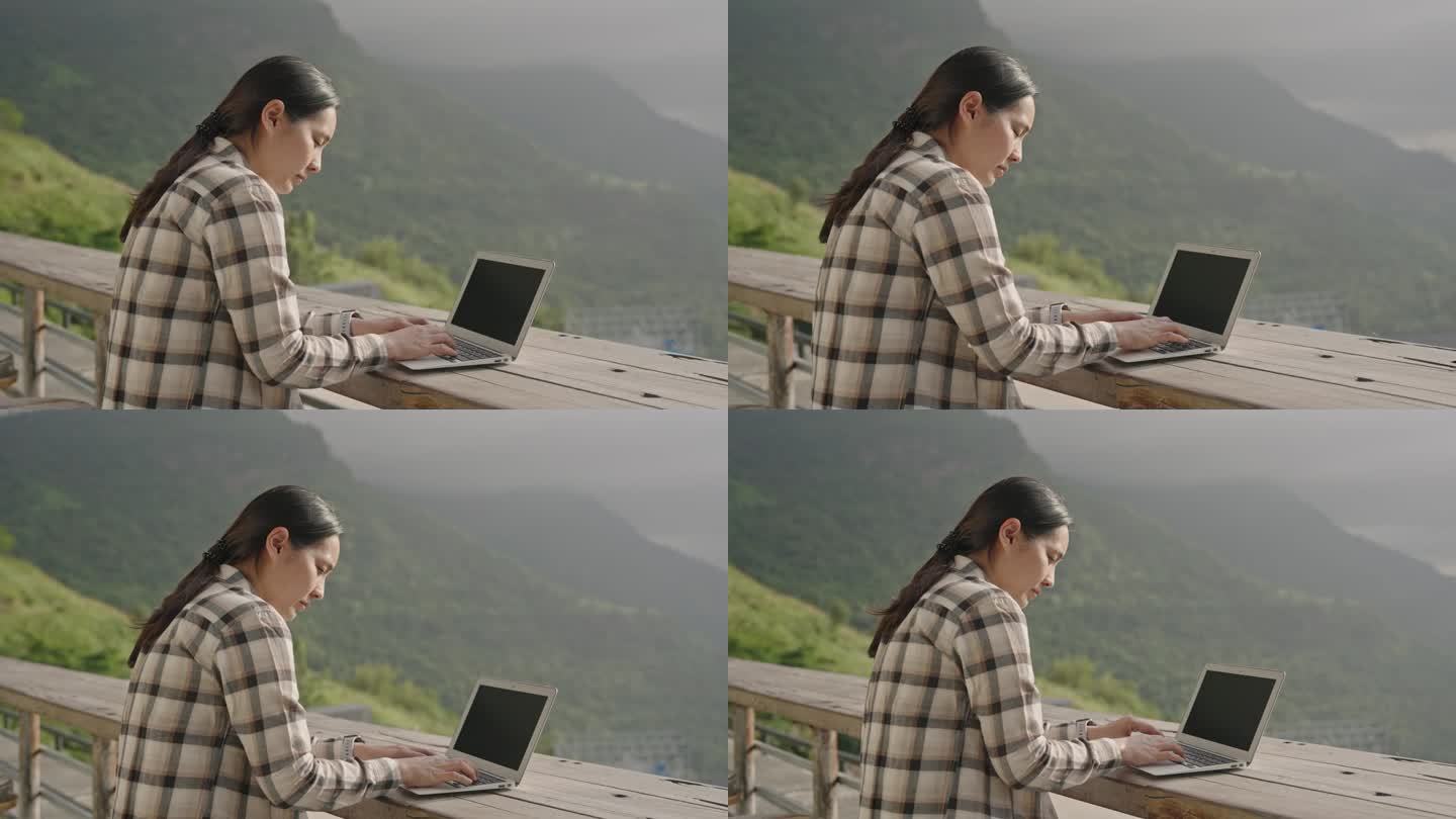 一位自由职业者在户外使用她的笔记本电脑