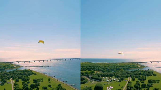 垂直无人机拍摄的风筝滑板飞过草坪和地平线上的蓝天