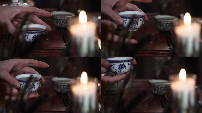 茶道，女子手捧热饮，背景是一根热蜡烛，特写