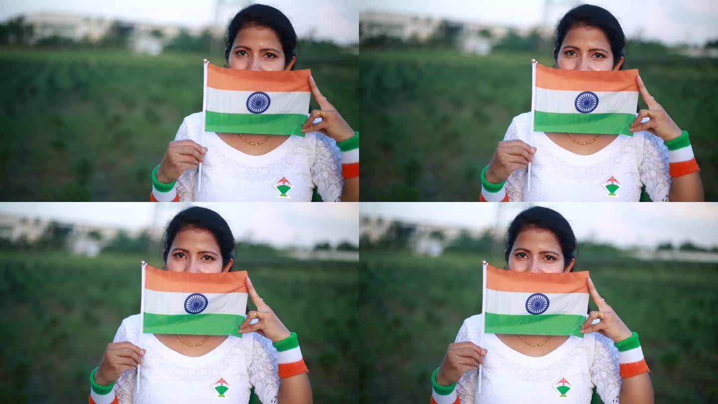 印度妇女躲在印度国旗后面