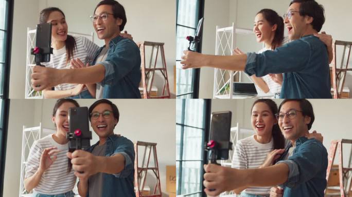 快乐快乐的亚洲已婚夫妇享受视频通话积极的家庭朋友交谈距离连接女性使用智能手机在线聊天拥抱展示新家公寓