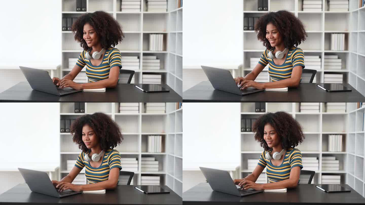 非洲女孩图书馆的女学生坐在书桌前用笔记本电脑和平板电脑搜索网上信息。