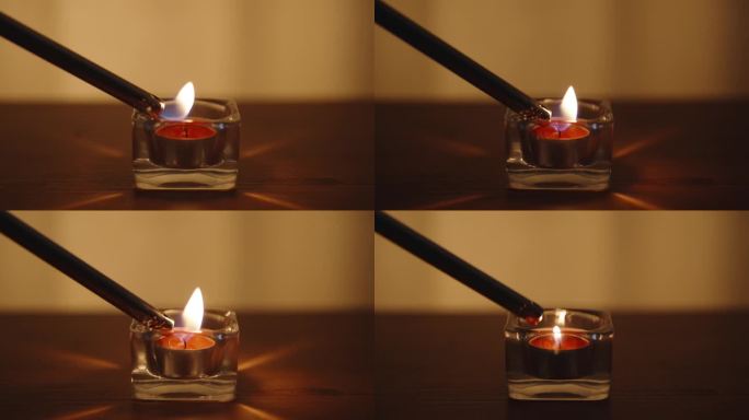 玻璃杯里的红烛。用长打火机点燃。在一张木桌上。