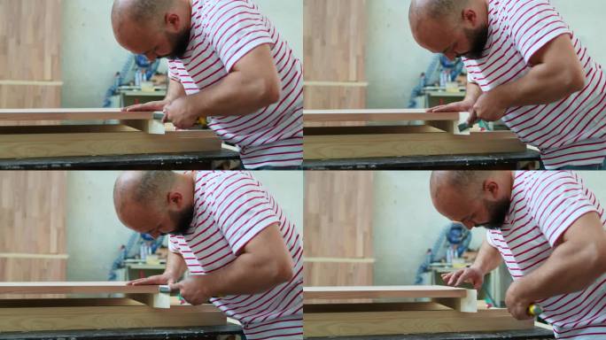 在木匠工场使用木雕刀的男子