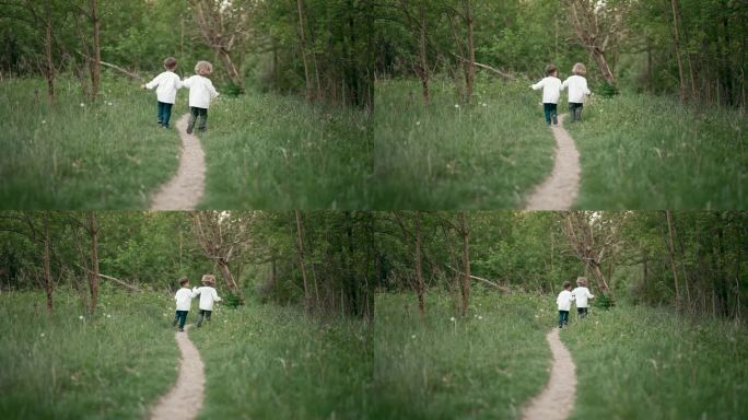 乌克兰小男孩欢快地沿着森林草坪或公园的小路奔跑。孩子们穿着传统刺绣衬衫在一起。乌克兰，兄弟，自由，民