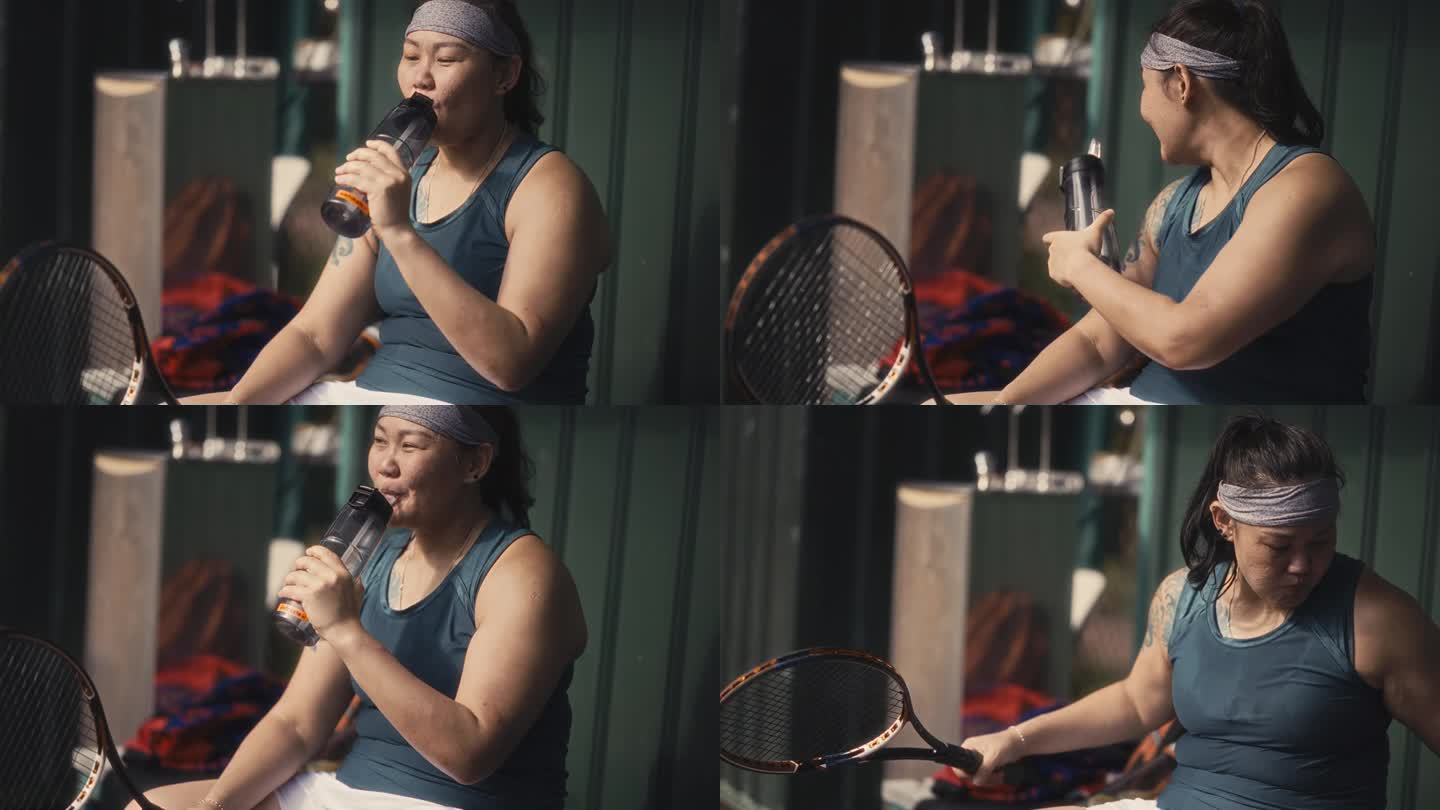 口渴的亚洲中国女网球运动员赛后喝水