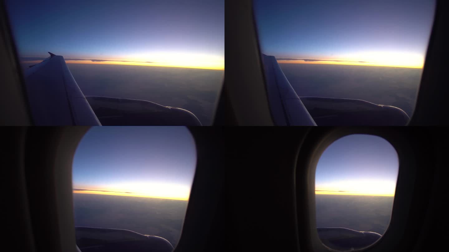 从飞机的机翼窗口看夕阳的天空，飞行，度假和旅行的概念
