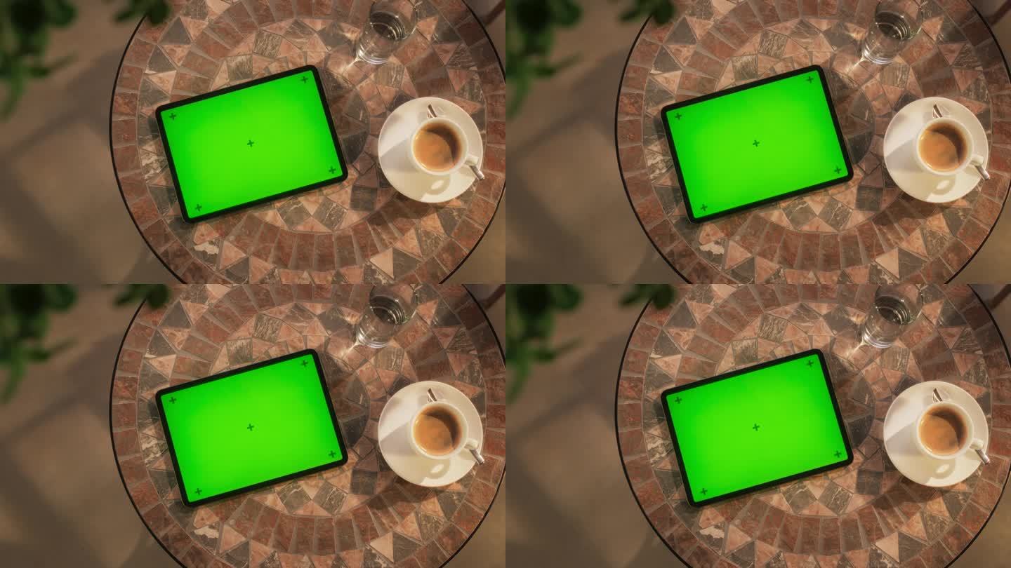 平板电脑的顶部静态视图与模拟绿屏显示。在繁忙的街道上，一个设备水平躺在咖啡桌上的电影镜头。在线数字营