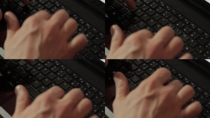 手提电脑键盘上的男人之手。关闭了。