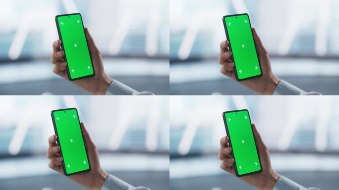 商人手持智能手机，看着绿色的Chromakey模拟显示屏。视频模板与运动跟踪器的数字营销，网站设计演