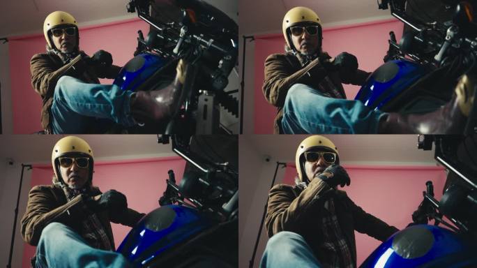 一个老摩托车手穿着皮夹克，戴着手套，坐在他时髦的摩托车上。