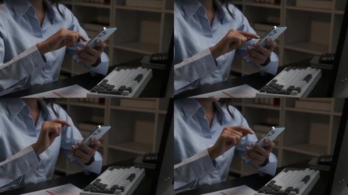亚洲女商人在晚上加班时使用智能手机。