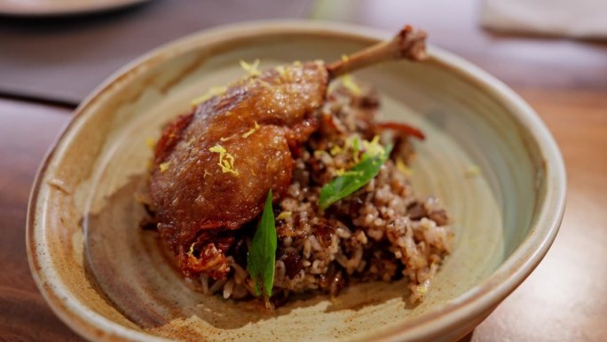 鸭肉配香米。鲜嫩可口的鸭肉和香浓的米饭和谐地融合在一起，提供了一道精致的菜肴，体现了美食的乐趣。