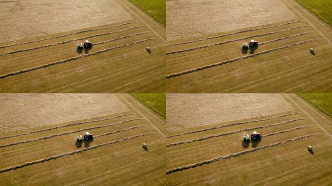 鸟瞰图干草捆拖拉机在草地上收割稻草成捆。拖拉机在田间行驶，用割下的稻草捆成捆