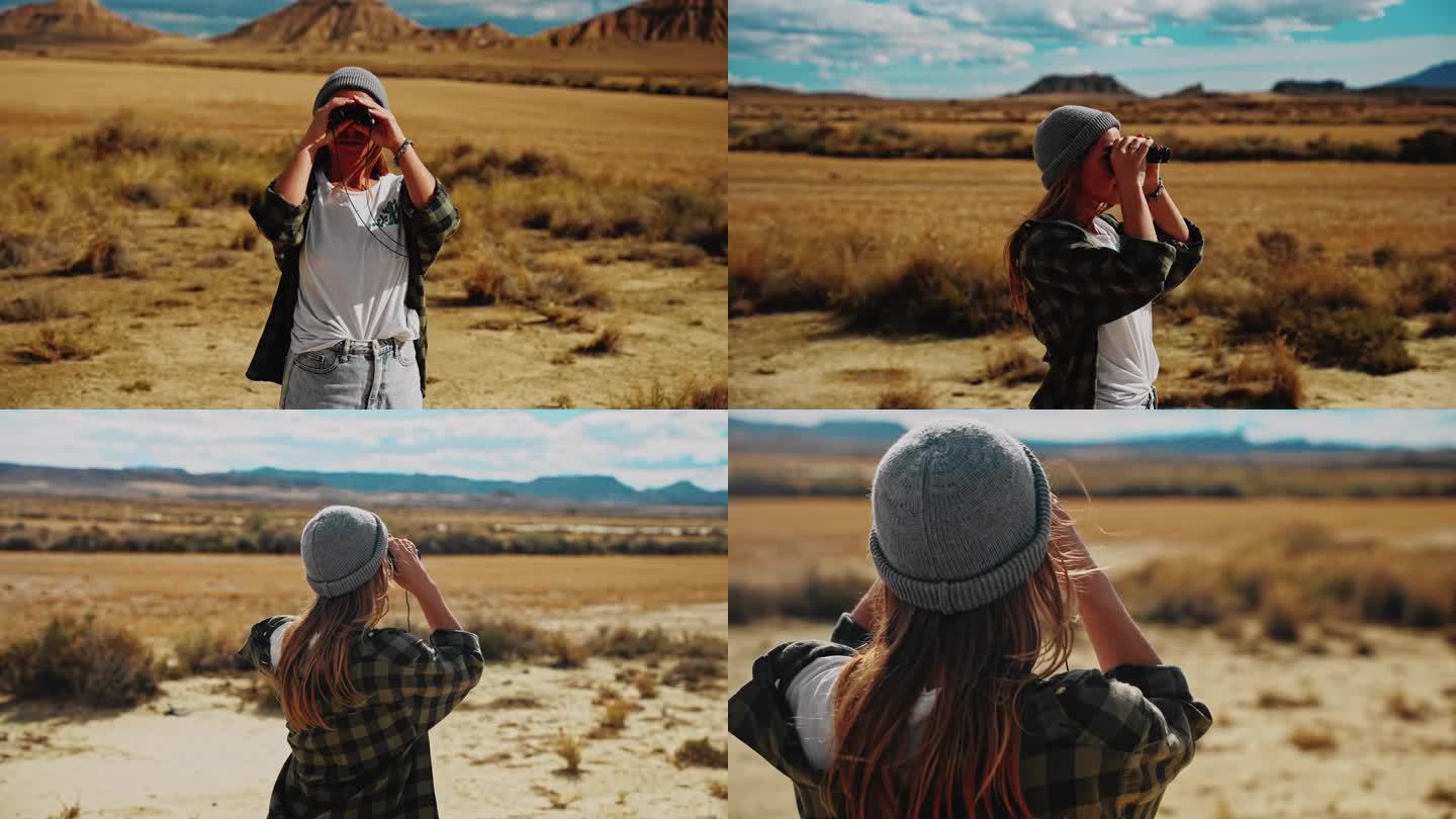 一名妇女用双筒望远镜在摩洛哥沙漠中寻找方向