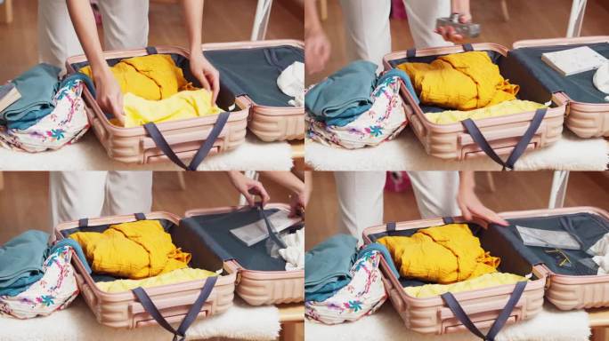 幸福亚洲女旅行家打包布的东西在手提箱准备去暑假旅行在家里的客厅里，女人打包手提箱暑假旅行