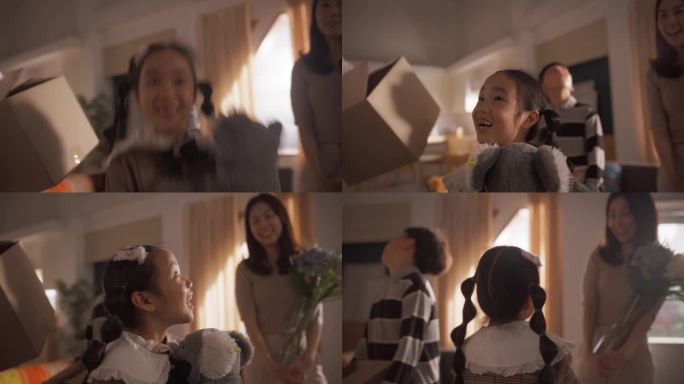 幸福的韩国小家庭为他们的新家感到兴奋:可爱的小女孩抱着她的泰迪熊蹦蹦跳跳，惊讶于她的新家是多么宽敞和